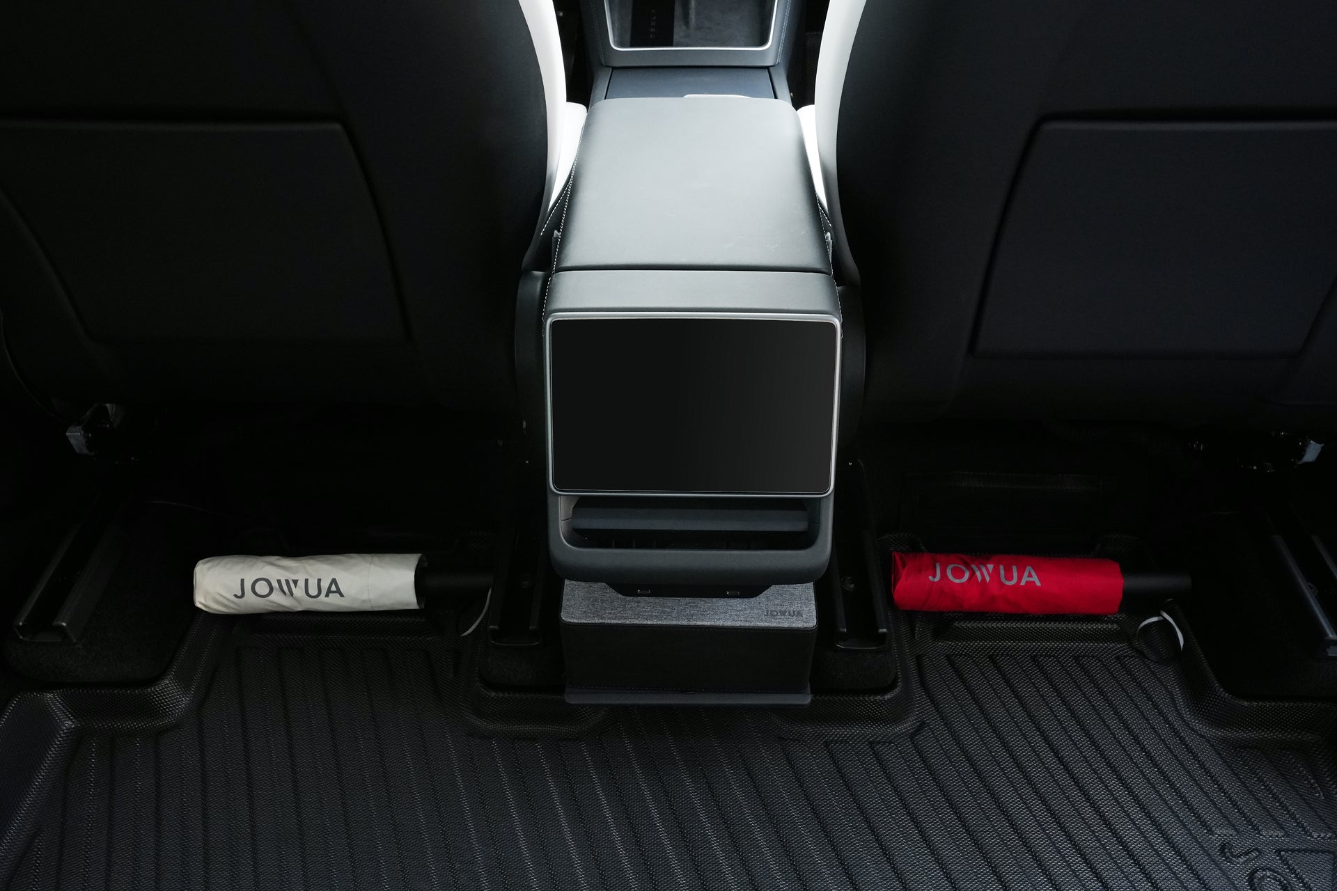 View of the Model Y backseat with a white and red umbrella stored under the center console on JOWUA Model Y 2025+ Interior / Trunk Full Coverage Liner Combo all-weather floor liners.