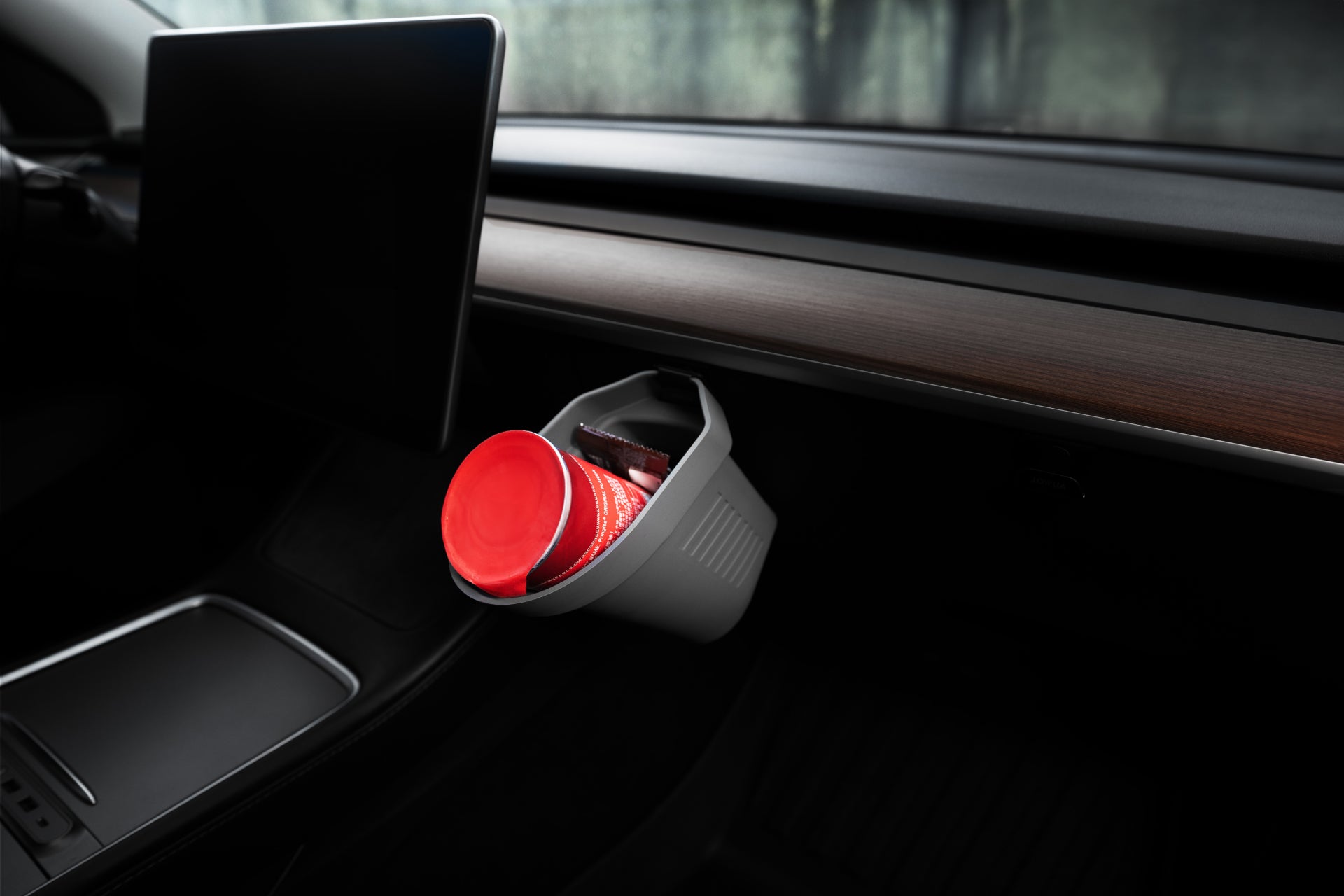 The interior of a Tesla Model showcases a sleek dashboard complemented by an eye-catching large black touchscreen and wood-grain finish. The JOWUA Door Side Storage Box (Set of 2) is subtly integrated for easy organization. A cylindrical compartment holds a red-capped bottle, and the seat is partially visible.