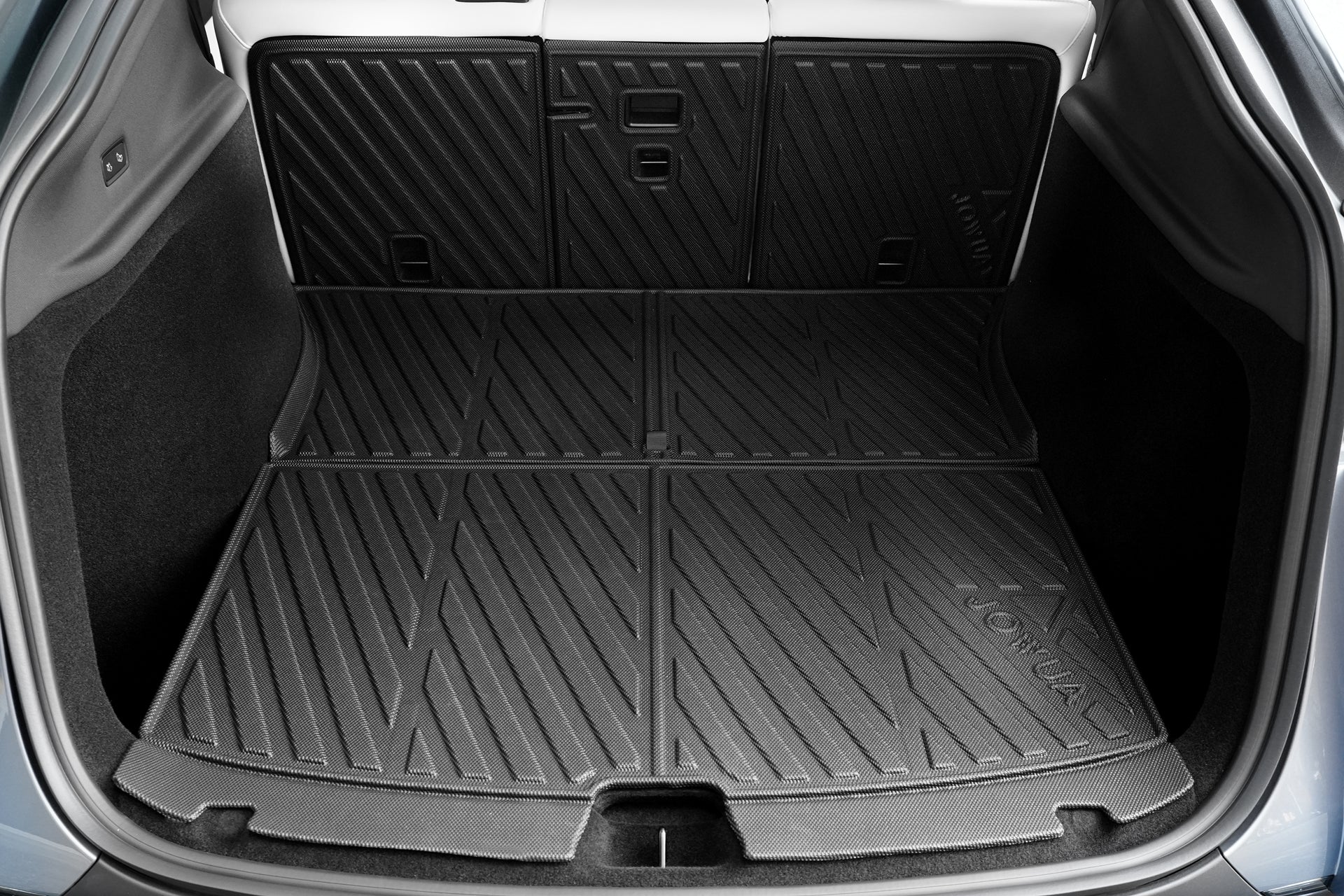 Close-up of a Tesla Model Y trunk with the JOWUA Model Y 2025+ Interior / Trunk Full Coverage Liner Combo, offering custom-fit, textured rubber protection for the entire cargo area and rear seat backs.
