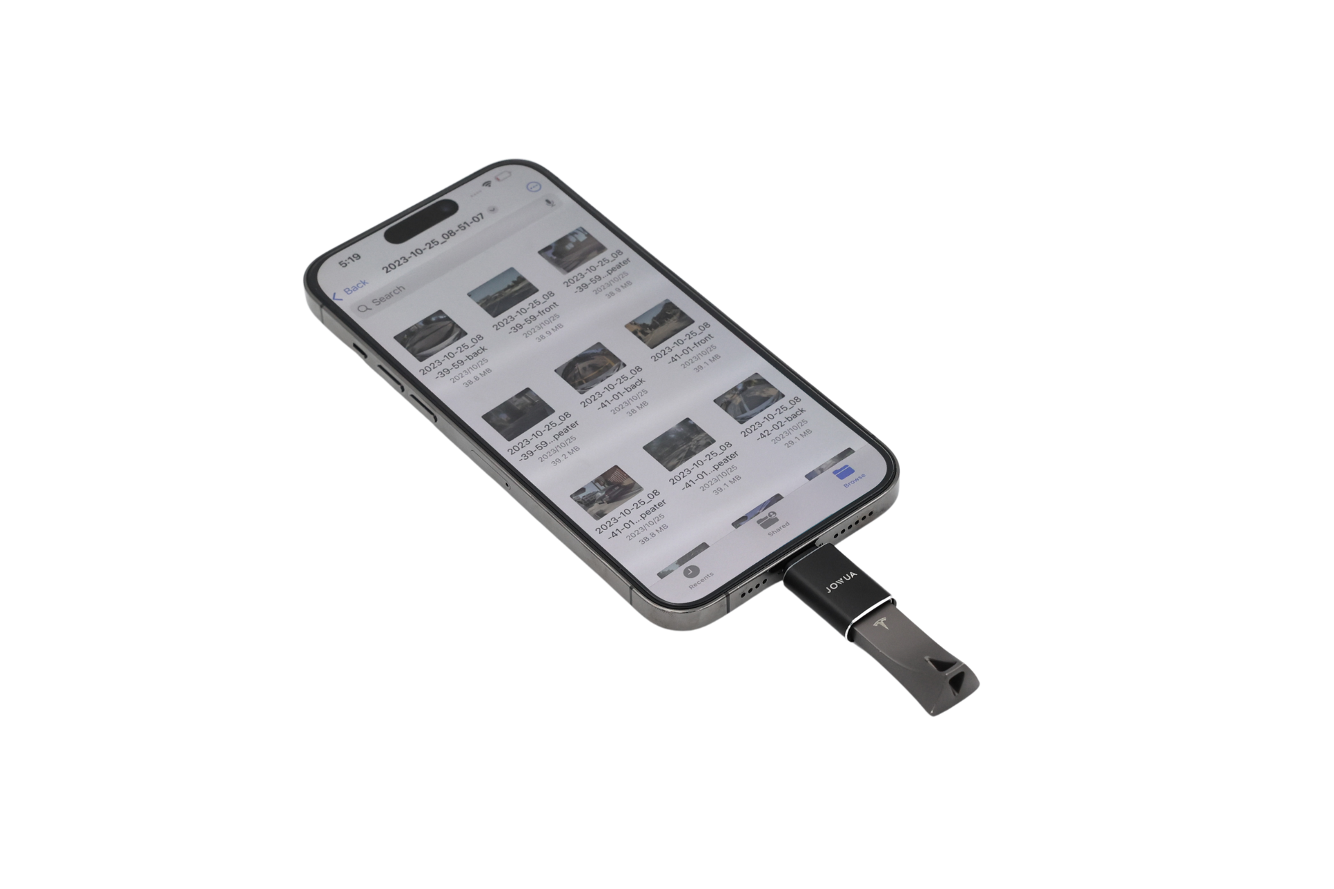 A JOWUA Sentry & DashCam Adapter Set OTG (USB-A to Type-C & Lightning) smartphone display features a grid of thumbnail images and text, similar to a file manager or gallery app, where the screen and connected USB device stand out against a simple black background.