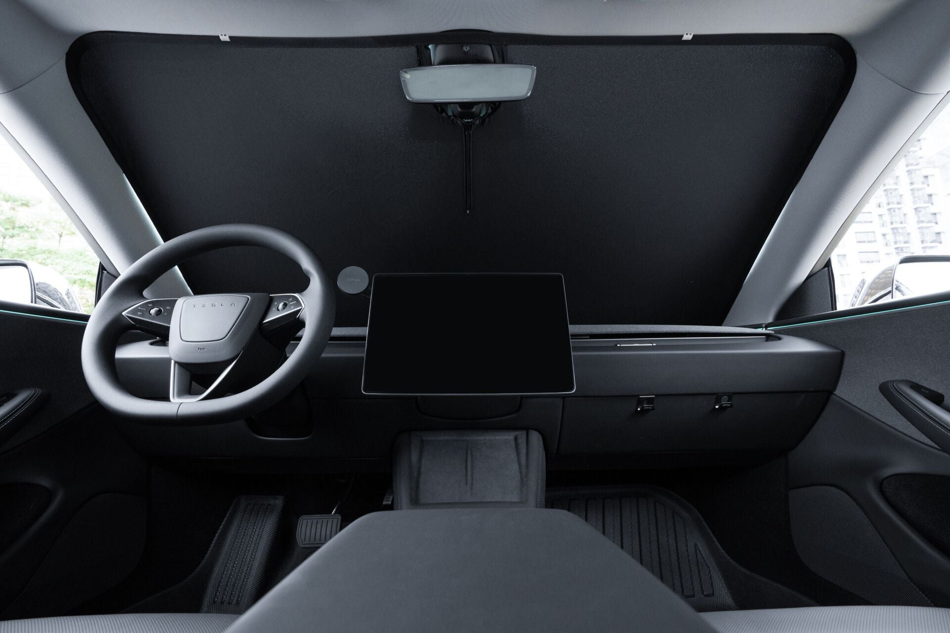 Discover the elegant interior of a Tesla Model 3, featuring a minimalist dashboard with a large central touchscreen display and digital rearview mirror. Revel in the comfort provided by the JOWUA Windshield Sunshade for ALL Model 3, expertly designed to offer UV protection.