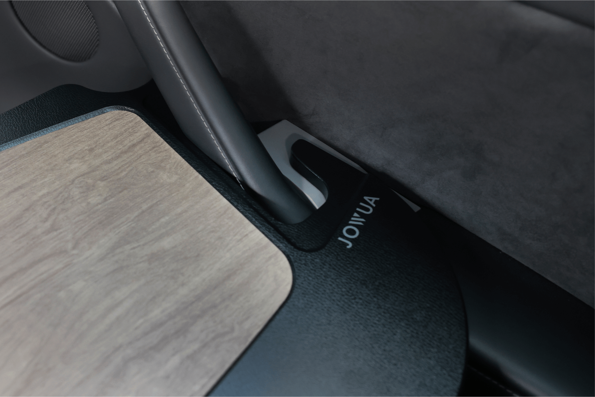 Close-up of a Tesla's interior featuring the Foldable Car Tray for Tesla, crafted with premium materials and supported by a gray structure. The word 